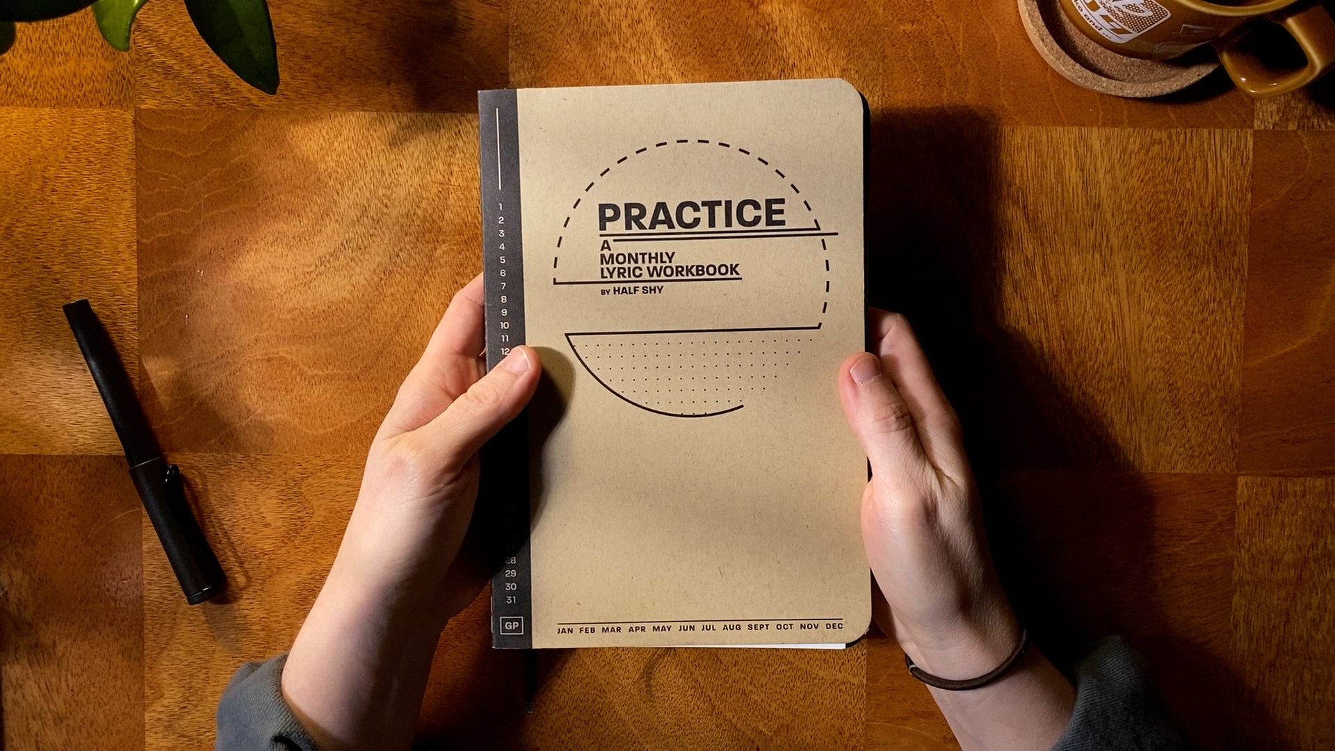 Practice Lyric Workbook cover held above a desk